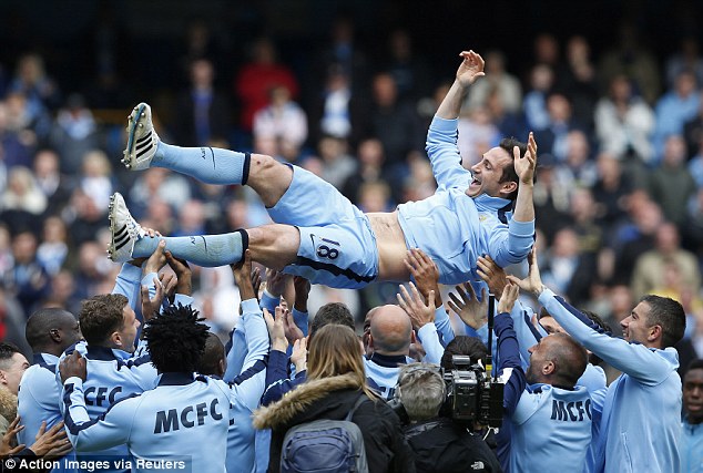 Lampard is thrown up in the air by his Manchester City team-mates following his final game at the club  