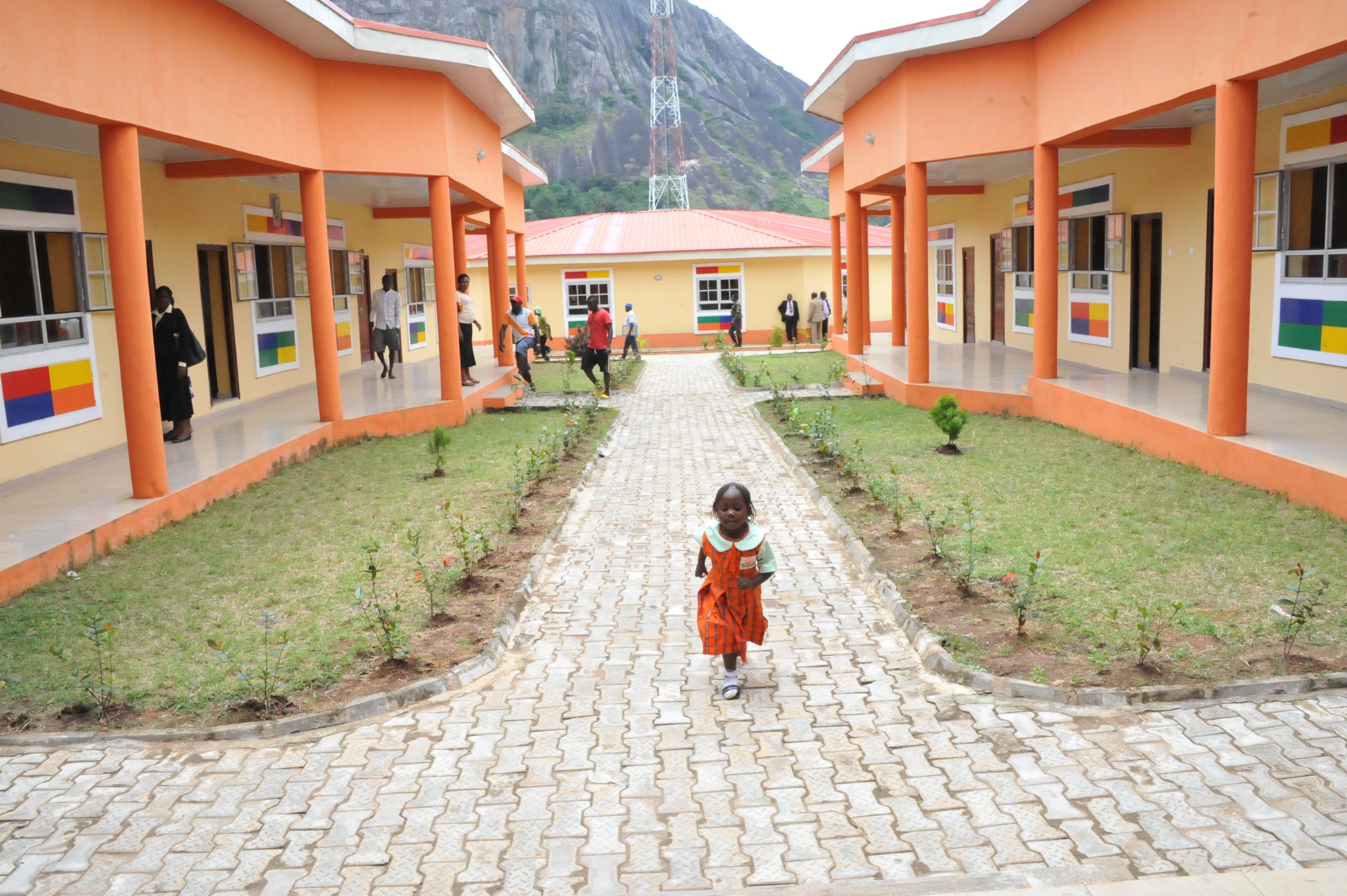 A little pupil walks in a Caring Heart Suburban School, Akure built by the Mimiko administration