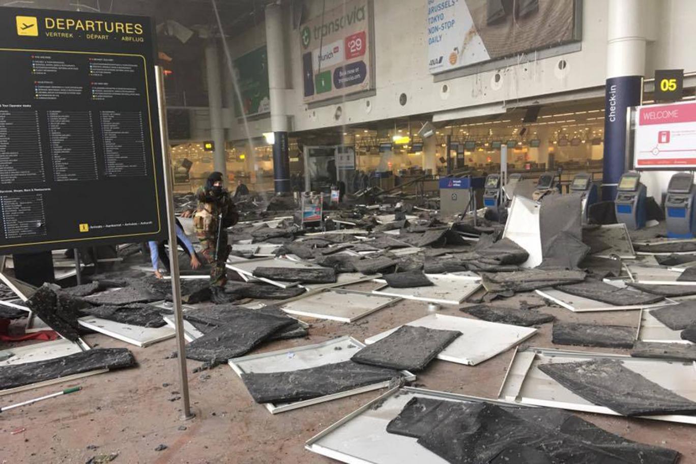 Aftermath: Tiles fell from the ceiling near check-in desks PA Wire