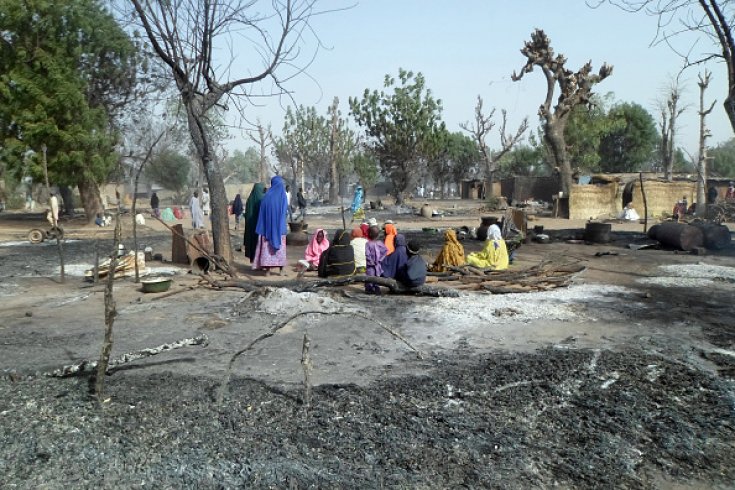Women and children sit among burnt houses after Boko Haram attacks at Dalori village | AFP/Getty