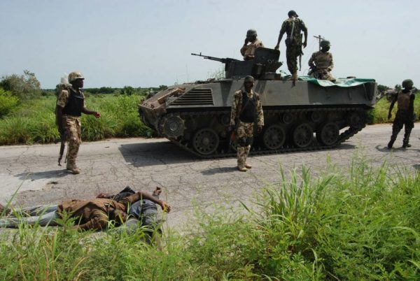 Nigerian soldiers around an armored tank