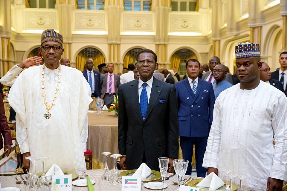 President Mbasogo (middle) flanked by President Buhari (left) and Governor Yahaya Bello of Kogi State, Nigeria (right) during the conferment of the award 