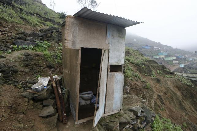 A toilet stands outside the Llamocca family home at Villa Lourdes in Villa Maria del Triunfo on the outskirts of Lima, Peru, October 7, 2015. REUTERS/Mariana Bazo